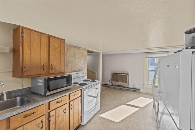 kitchen featuring white appliances, a wall mounted AC, sink, and baseboard heating