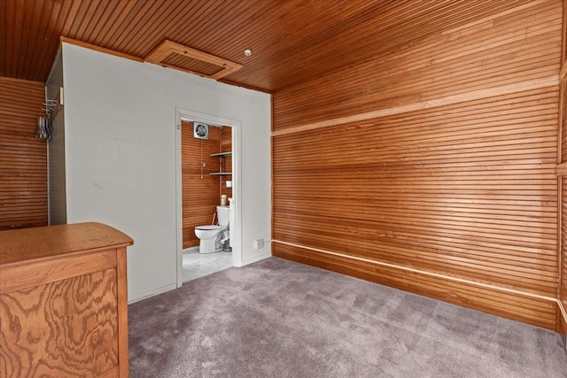 interior space featuring wooden walls and wooden ceiling