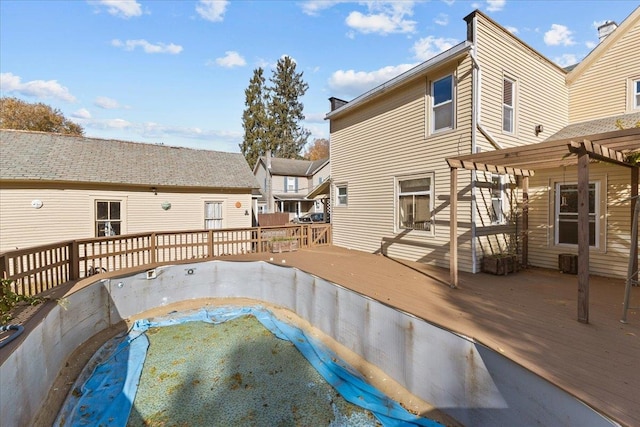 view of swimming pool with a wooden deck and a pergola