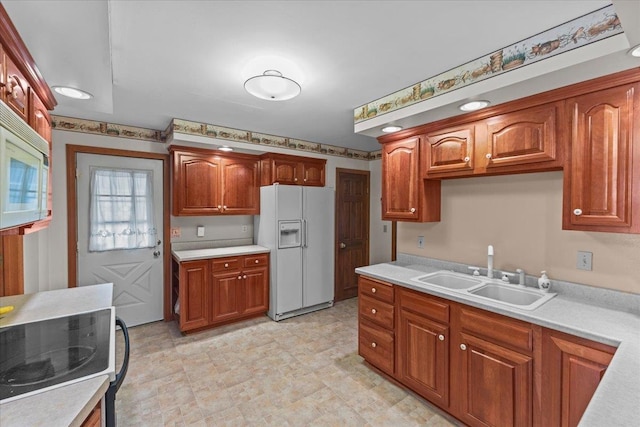 kitchen featuring sink and white appliances