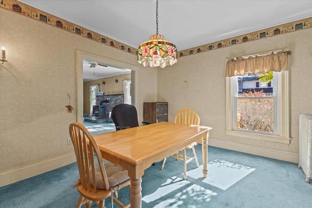 carpeted dining area with crown molding