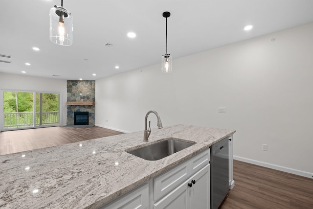 kitchen with dishwasher, sink, hanging light fixtures, white cabinets, and dark hardwood / wood-style floors