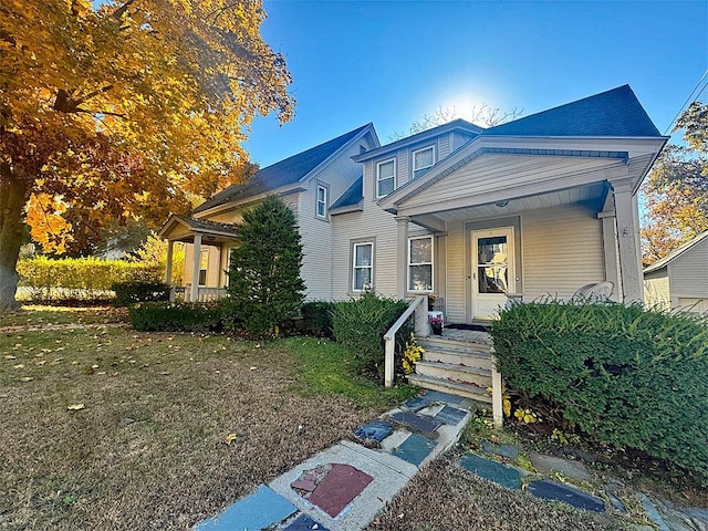 view of front of home with a porch and a front lawn