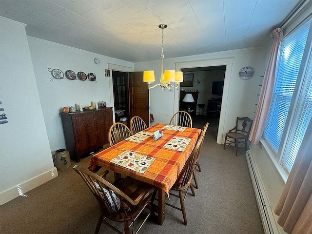 dining space featuring a chandelier and a baseboard heating unit