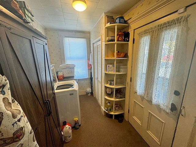 washroom featuring washer / dryer and dark carpet