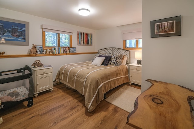 bedroom featuring multiple windows and light wood-type flooring