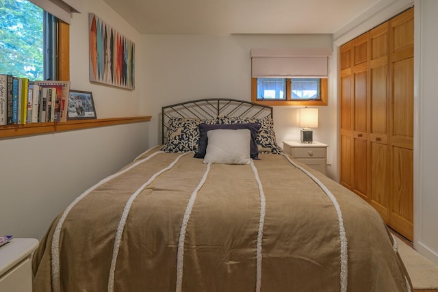 bedroom featuring multiple windows and a closet