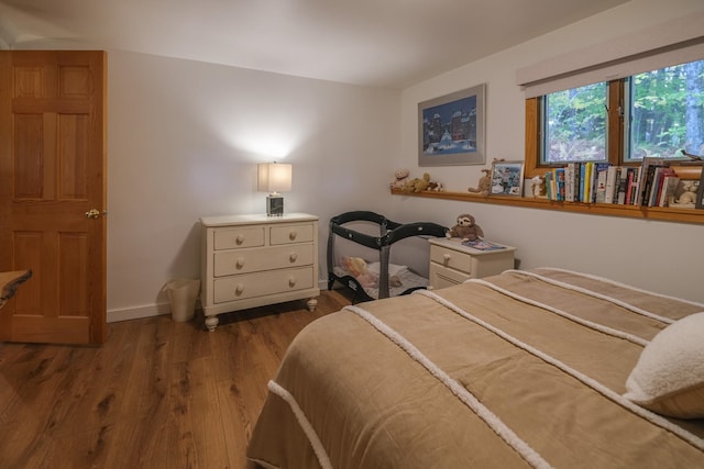 bedroom with dark hardwood / wood-style flooring