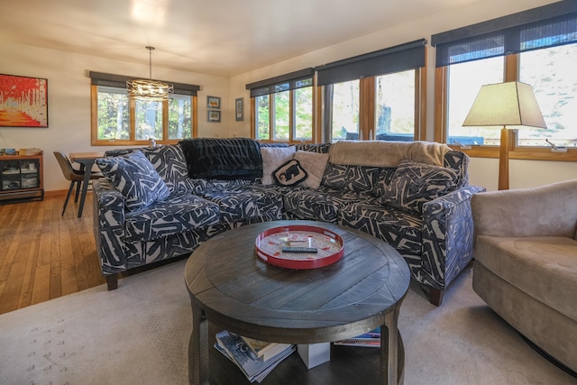 living room with wood-type flooring and a chandelier