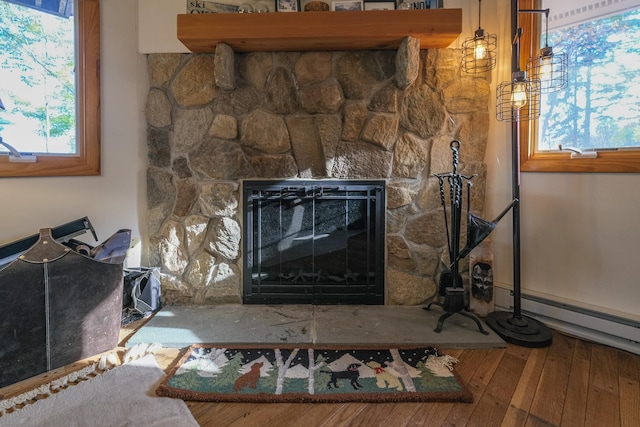 room details featuring hardwood / wood-style floors, baseboard heating, and a fireplace