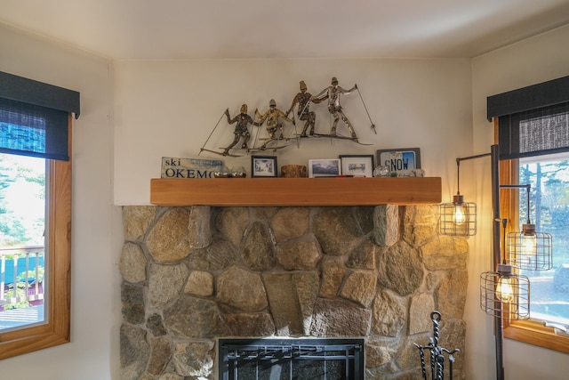 interior details featuring a stone fireplace and heating unit