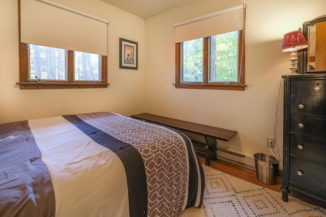109 Upper Loop, Ludlow, VT 05149 - bedroom featuring wood finished floors, a baseboard heating unit, and baseboards