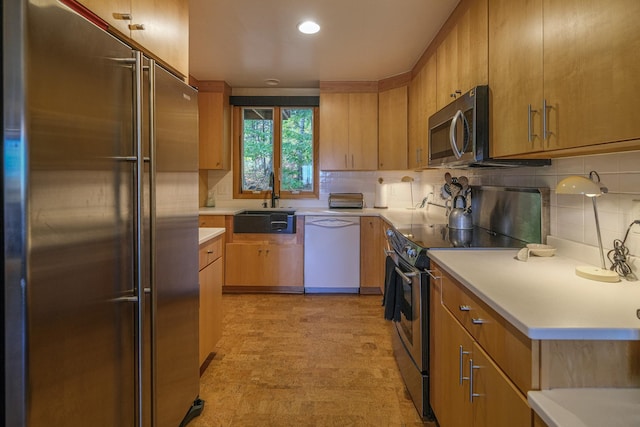 109 Upper Loop, Ludlow, VT 05149 - kitchen featuring appliances with stainless steel finishes, a sink, decorative backsplash, light countertops, and recessed lighting