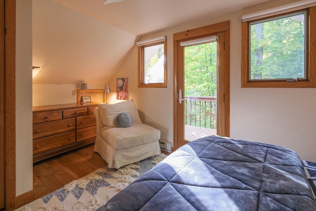 bedroom featuring access to outside, a baseboard radiator, vaulted ceiling, and hardwood / wood-style flooring