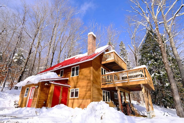 109 Upper Loop, Ludlow, VT 05149 - view of front of house with a chimney and a wooden deck