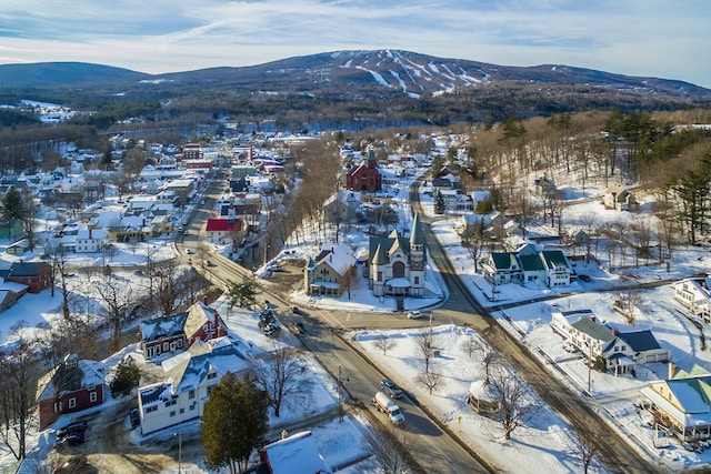 snowy aerial view featuring a mountain view