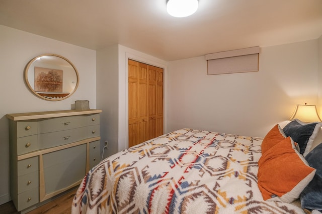 bedroom with hardwood / wood-style floors and a closet