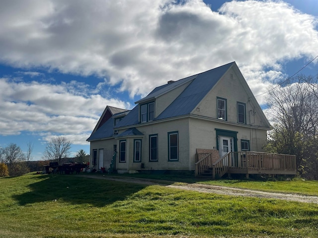 view of side of property with a deck and a yard