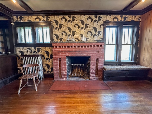 unfurnished living room with wooden walls, hardwood / wood-style flooring, plenty of natural light, and a fireplace