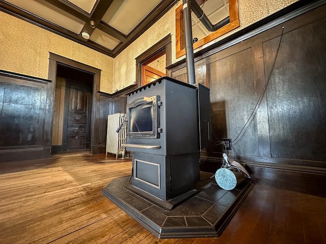 kitchen with hardwood / wood-style floors, beam ceiling, coffered ceiling, and a high ceiling