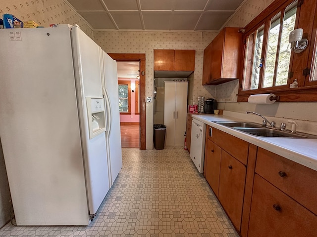 kitchen featuring white appliances and sink