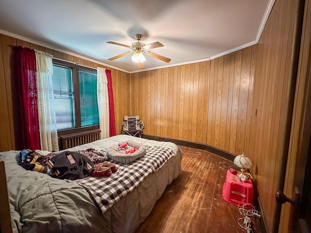 bedroom with ceiling fan, crown molding, dark hardwood / wood-style floors, and wood walls