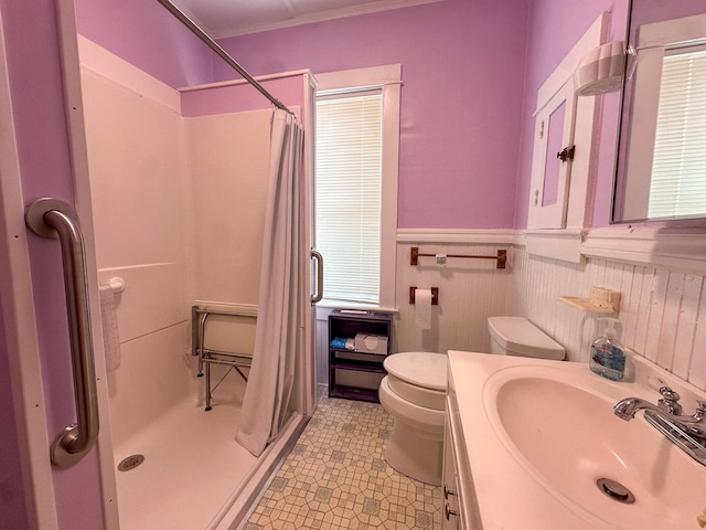 bathroom featuring vanity, curtained shower, ornamental molding, and toilet