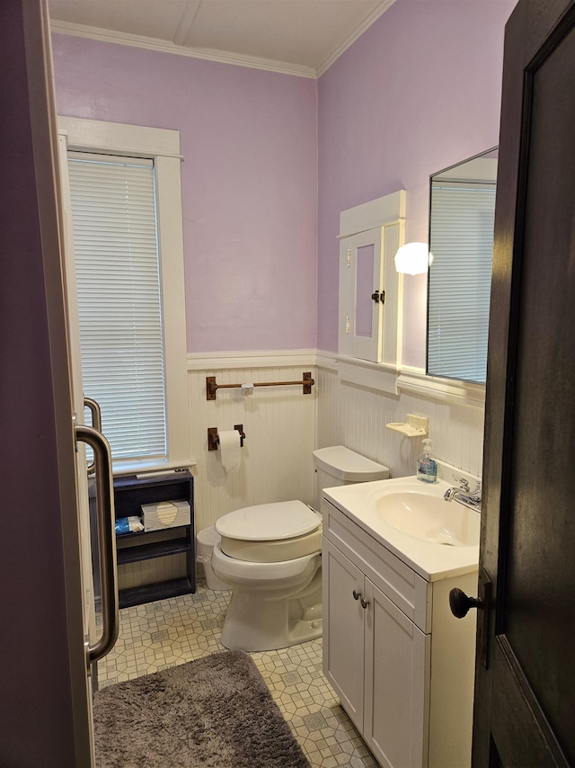 bathroom with vanity, toilet, tile patterned floors, and ornamental molding