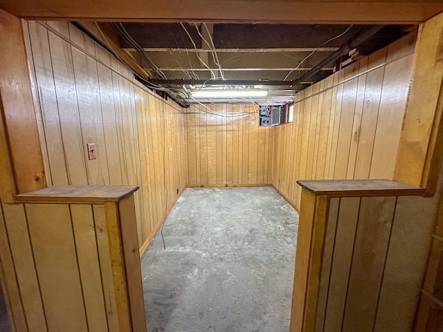 basement featuring wooden walls