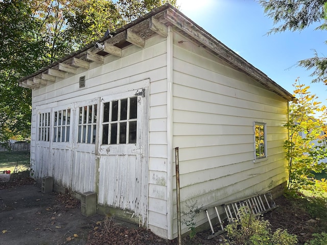 view of property exterior with a storage unit