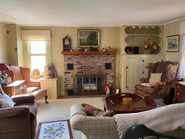 44 Pleasant View Rd, Bradford, NH 03221 - carpeted living area with crown molding and a fireplace