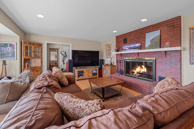 living room featuring wood-type flooring and a fireplace