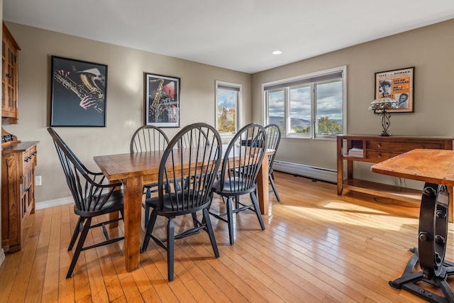 dining room featuring a baseboard radiator and light wood-type flooring