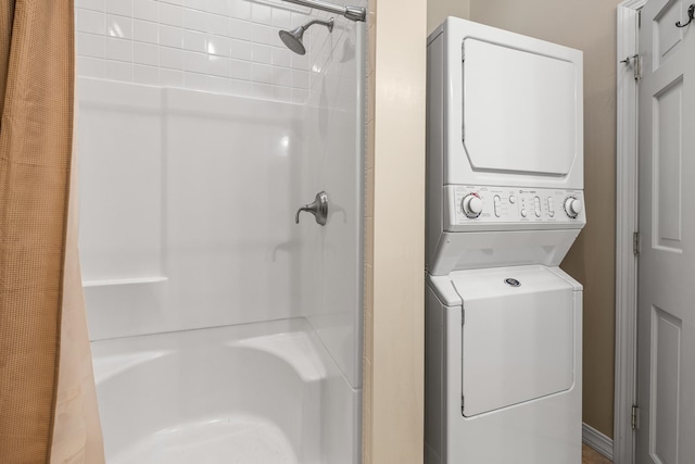 laundry room with stacked washer / drying machine