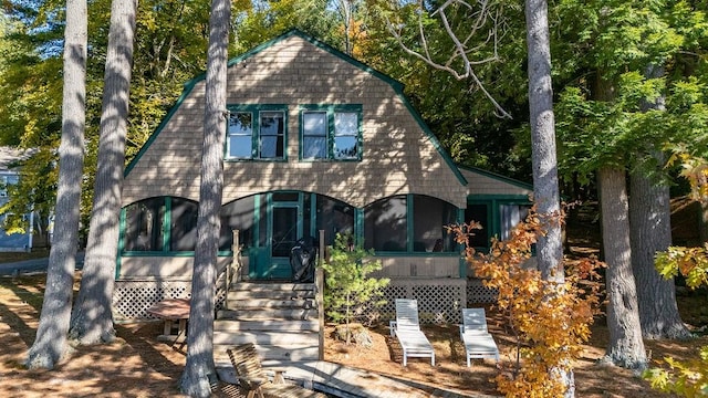 back of property with a sunroom