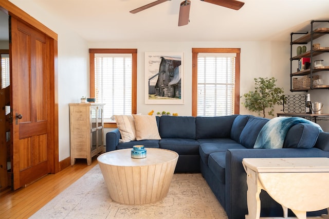 living room with ceiling fan, light wood-type flooring, and a wealth of natural light