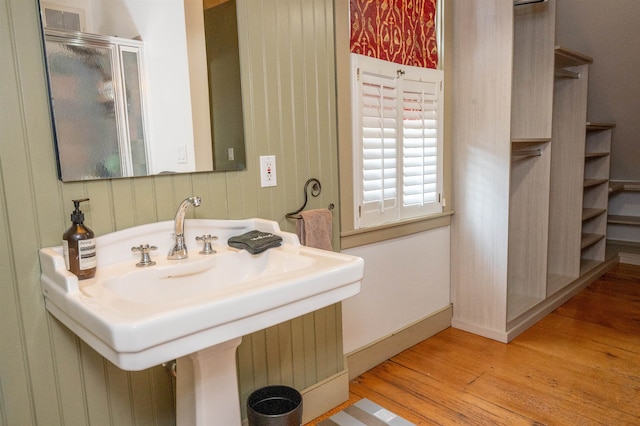 bathroom featuring a shower with door and hardwood / wood-style flooring