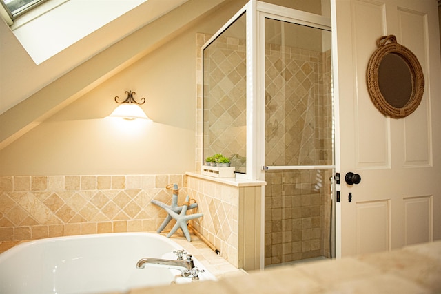 bathroom with a skylight and separate shower and tub