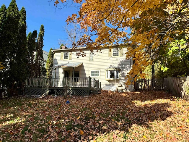 rear view of house featuring a wooden deck