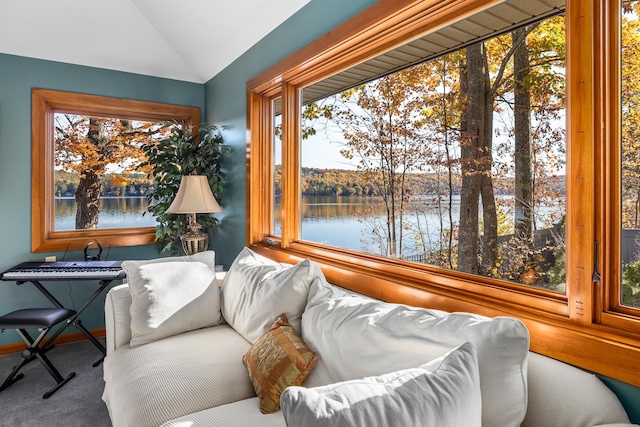 sunroom featuring a water view and vaulted ceiling