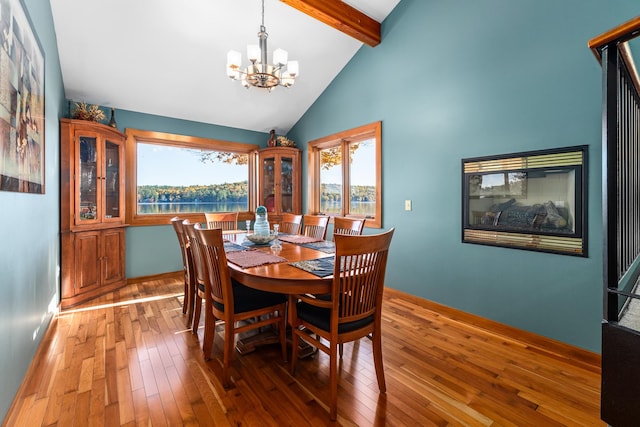 dining room with a chandelier, dark hardwood / wood-style floors, high vaulted ceiling, and beamed ceiling