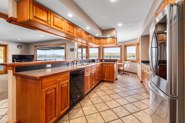 kitchen with dishwasher, stainless steel fridge, plenty of natural light, and sink