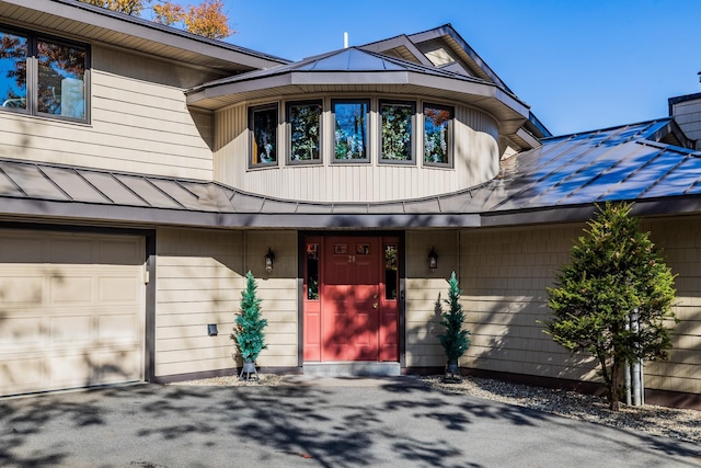 20 Bonardi Dr, Enfield, NH 03748 - view of front of home featuring metal roof, a garage, and a standing seam roof