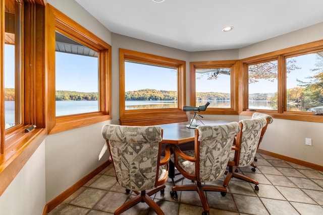 dining area with a water view and a wealth of natural light