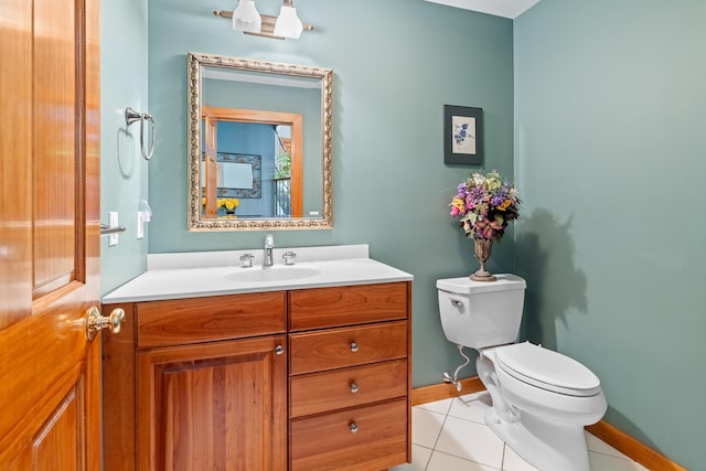 bathroom with tile patterned flooring, vanity, and toilet