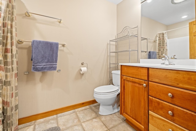 bathroom with tile patterned flooring, vanity, and toilet