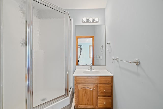 bathroom with tile patterned flooring, vanity, and an enclosed shower