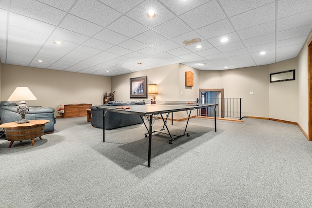 rec room featuring a paneled ceiling and light colored carpet