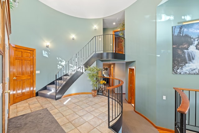 tiled foyer with a high ceiling