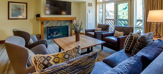 living room with a tiled fireplace